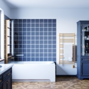 sorano brushed gold towel warmer on blue tiled wall - Choosing the Right Towel Warmer Finish